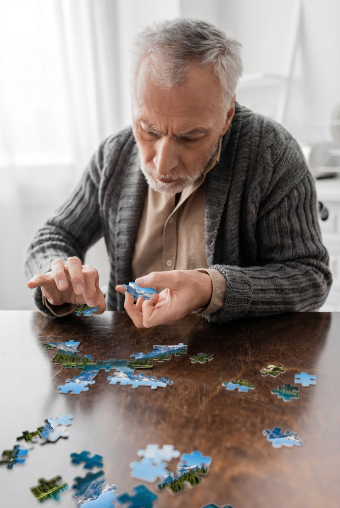 Memory impaired man doing puzzle
