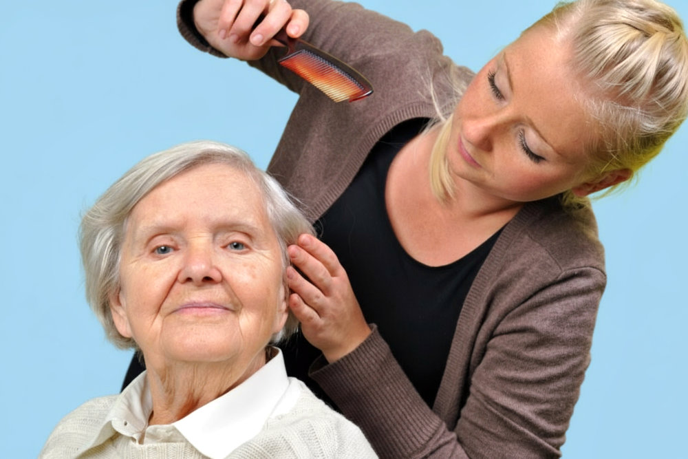 Elderly woman getting her hair brushed by a respite care giver.