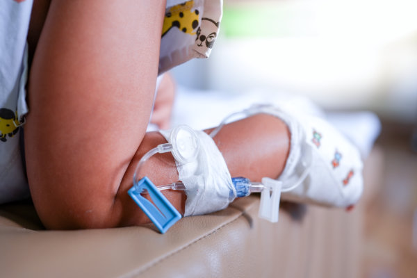 Shot of peripheral venous catheter in a child's leg