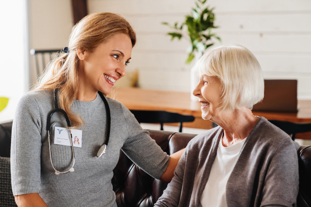 Home care nurse visits senior woman patient