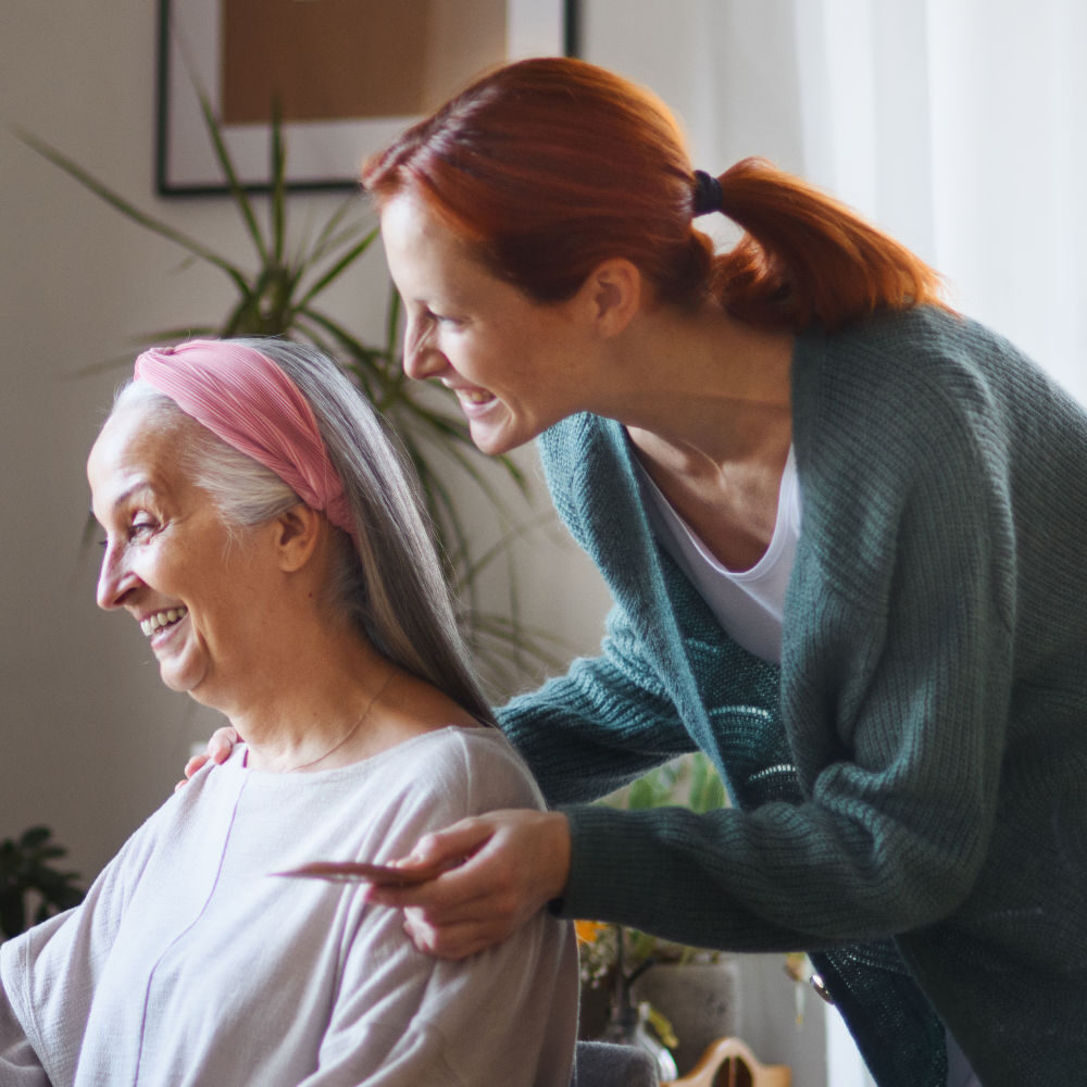 Caregiver helping her mother with a make up.