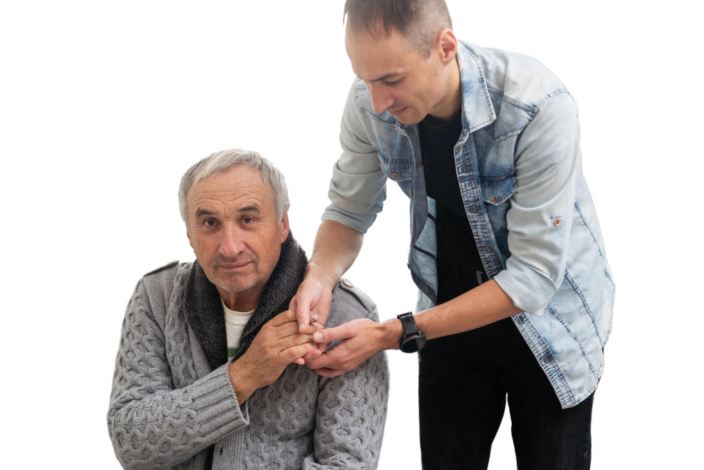 Elderly man being helped by his son in their home