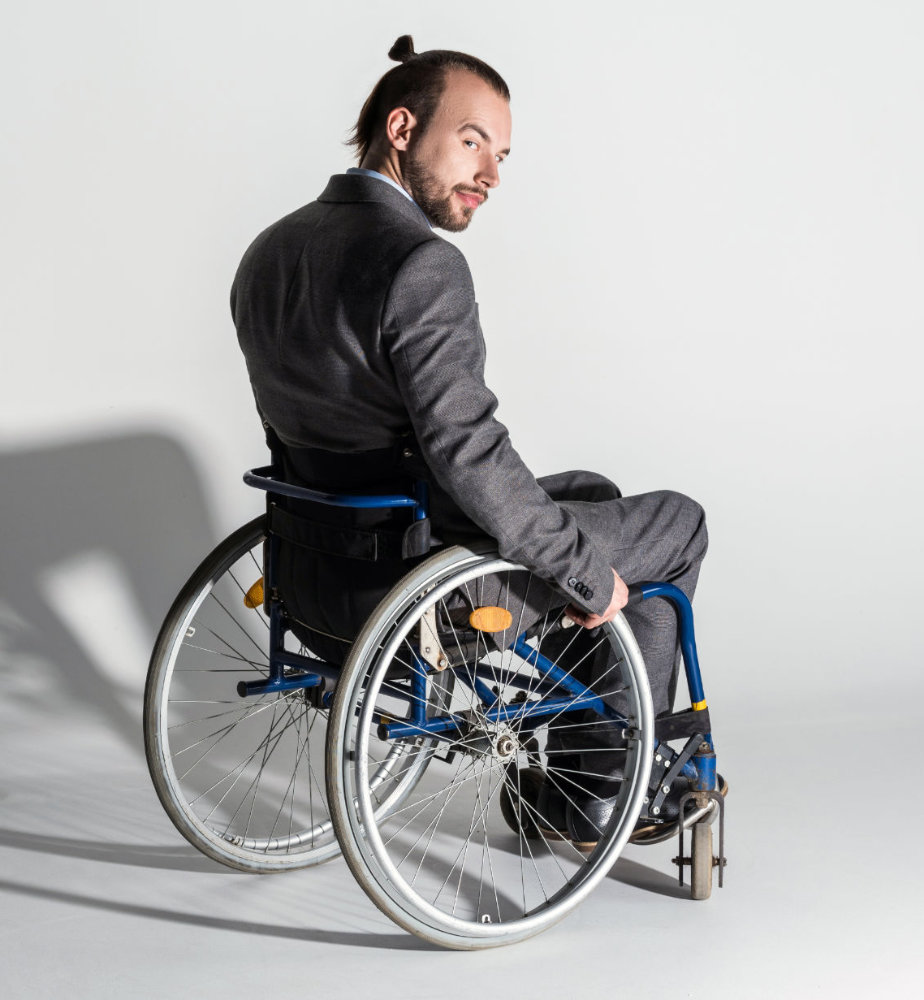 Young physically handicapped businessman in a wheelchair
