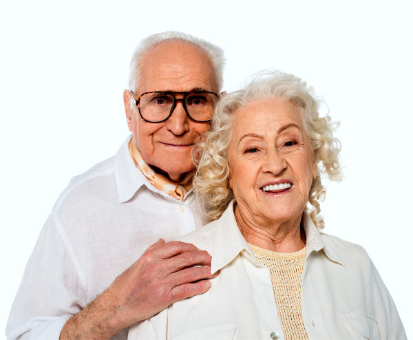 elderly man in casual clothes hugging wife and looking at camera